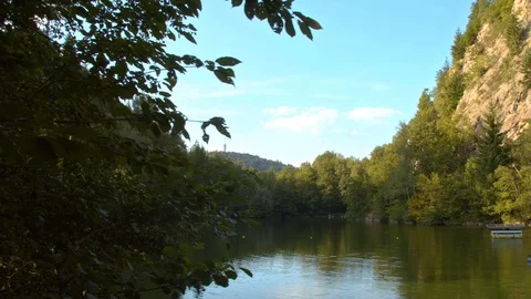 Lake in the Forest with Water Reflection of Blue Cloudy Sky  Stock Footage 129332432