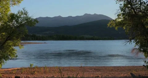 Lake framed by trees Vídeos de archivo 53821817