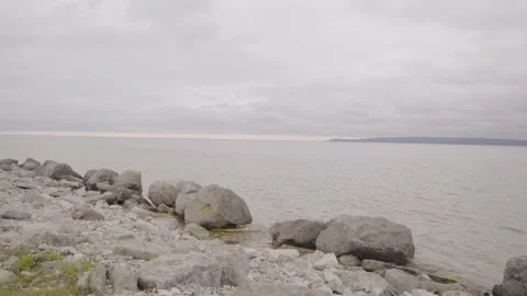 Lake Front Rocky Beach on a Cloudy Day Stock Footage 219225098