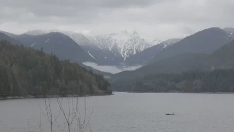 Lake in front of Snowy Mountain Range, Cloudy Sky 스톡 동영상 219530352