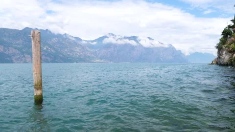 Lake Garda with cloudy alps in background. Malcesine, Italy Stock Footage 316976969