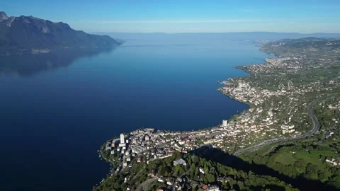 Lake Geneva shoreline and Alpine mountains on clear day Stock Footage 322077853