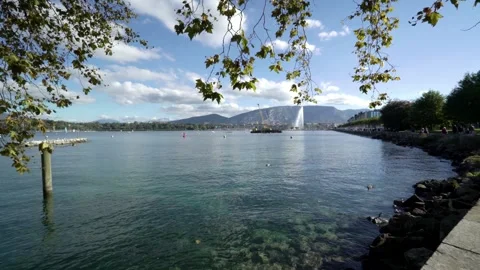 Lake Geneva on a sunny summer day with mountains and a fountain Stock Footage 261301853