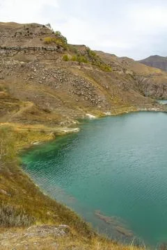 Lake Gizhgit is a large reservoir of green color, Elbrus district, Russia. Stock Photos