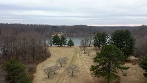 Lake going forward over trees aerial shot Seneca Creek State Park Stock Footage 106596583