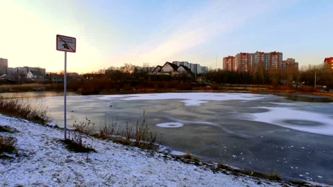 Lake half covered in ice with ducks Stock Footage 220501994