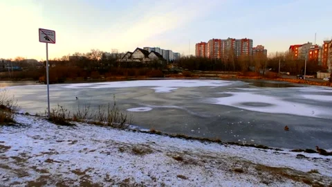 Lake half covered in ice with ducks Stock Footage 220502594