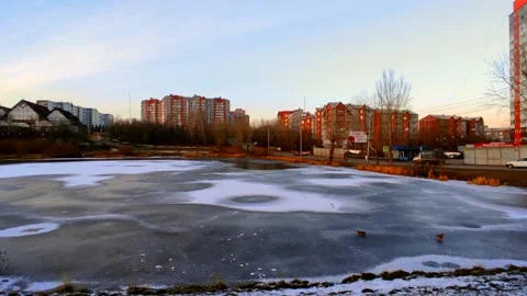 Lake half covered in ice with ducks Stock Footage 220502670