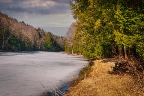 Lake ice is slowly melting on the shores of Cole Park Lake in Upstate NY Stock Photos