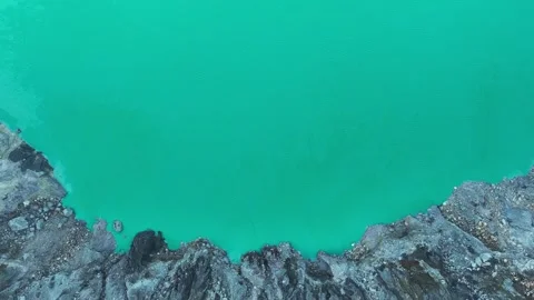 Lake inside a volcano with smoke Stock Footage 247391687