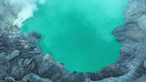 Lake inside a volcano with smoke Stock Footage 247391699