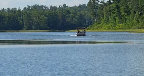 LAKE ITASCA, MN - 12 AUG 2024: People on pontoon on Lake Itasca Stock Footage 290804218