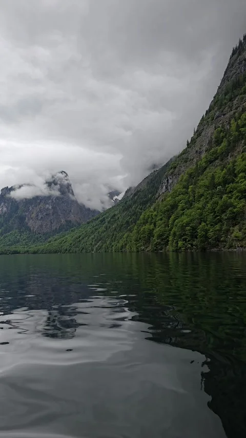  Lake Koenigssee, surrounded by steep cliffs, dense forest Stock Footage 309024799
