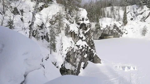 Lake in a marble quarry under snow in winter Stock Footage 104586597
