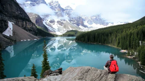 Lake Moraine reflections Banff National Park hiker, Canada Stock Footage