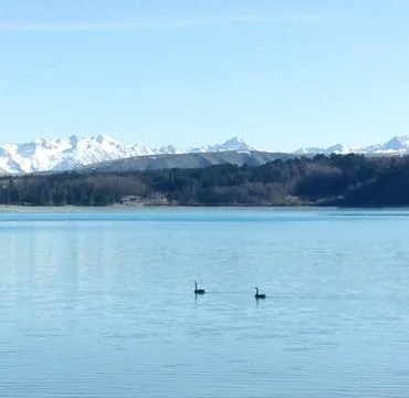Lake with mountains covered with snow Stock Photos