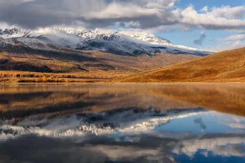 Lake mountains reflection snow clouds autumn Stock Photos