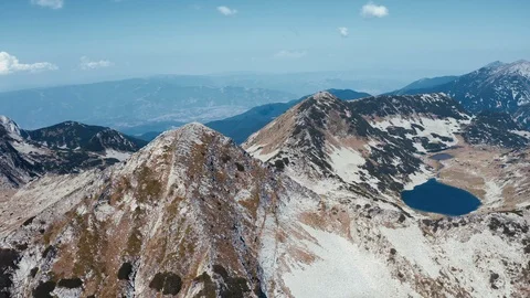 Lake in mountains in shape of bear with blue clear water aerial view 스톡 동영상 123545007