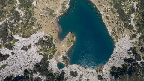 Lake in the mountains shape of bear with blue clear water reflection of sunlight 스톡 동영상 123545371
