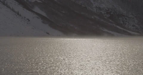 A lake in the mountains with sun reflecting off the surface Stock Footage 150491708