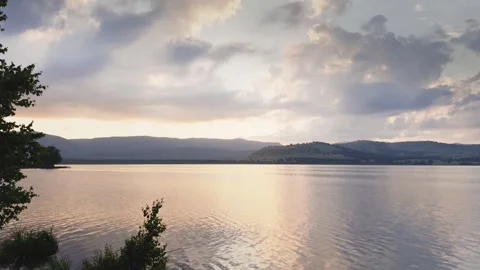 Lake in the mountains at sunset. Clouds over the mountains. Stock Footage 278908366