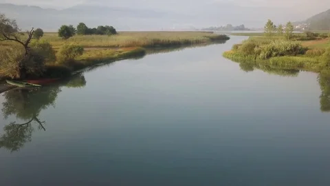 Lake Plav slow forwards tracking shot along lakeside UHD Stock Footage 80986225