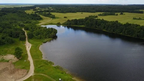 Lake Polonskoe. Fields Tractor on the road Stock Footage 100871200