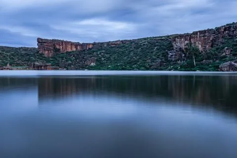 Lake pristine with mountain background and bright sky long exposure shot at d 스톡 사진