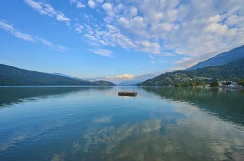 Lake reflection bathing raft sky clouds sunrise summer Lake Millstatt Doebriach Stock Photos