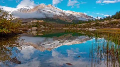 Lake Reflection of Massive Mountain Snow Covered Peak In Banff Mt K2 PAN IN T Stock Footage 136642318