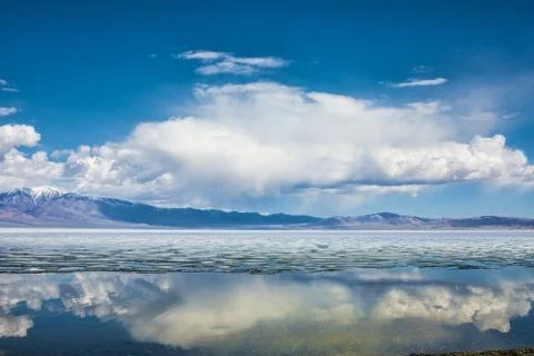 Lake with reflection of mountains and clouds on water Stock Photos