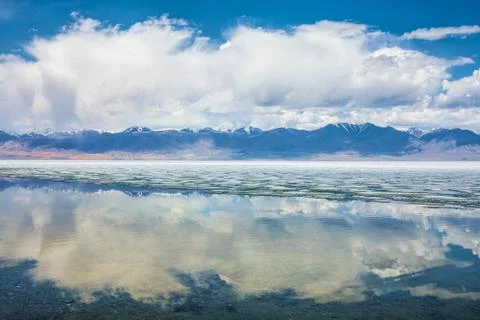 Lake with reflection of mountains and clouds on water Stock Photos