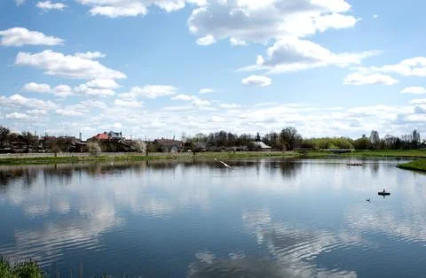 A lake with reflective clouds in the water. Selective focus Stock Photos