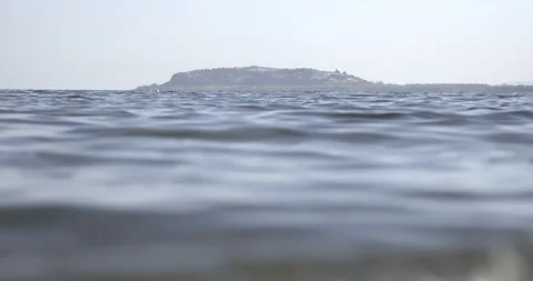 Lake Sevan Armenia Low Angle Wide Calm Water with Sevan Peninsula 4K Stock Footage 326637123