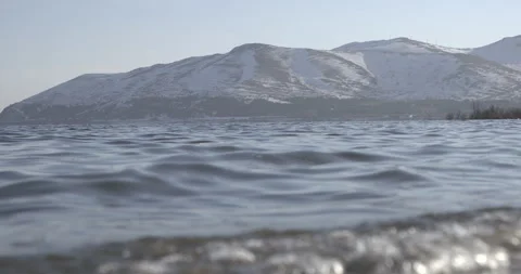 Lake Sevan Armenia Low Angle Wide Shot with Mountains and Open Water 4K Stock Footage 326637131