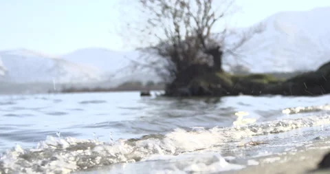 Lake Sevan Armenia Shore Foreground Bushes Low Angle Water 4K Stock Footage 326638272