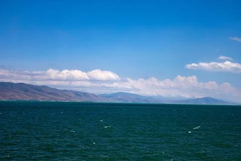 Lake Sevan with mountains in the background Stock Photos