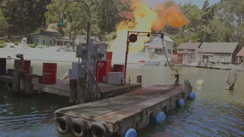 Lake side gas pump fire explosion slow motion Stock Footage 196897208