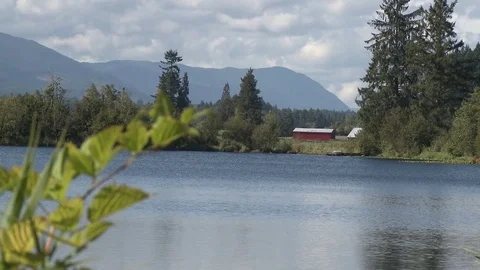 Lake with small barn in distance Stock Footage 75245101