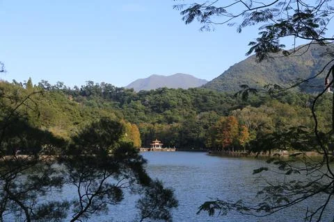 A lake with a small building in the background Stock Photos
