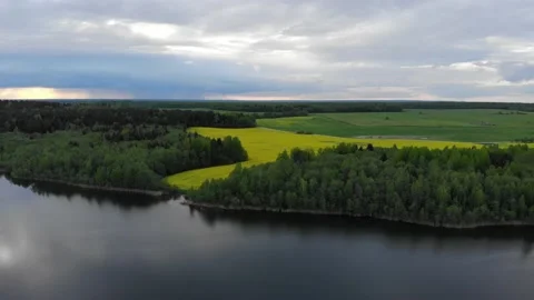 Lake in spring sunset 4k aerial top view. Fly above water of lake Dolgoe 動画素材 154532985