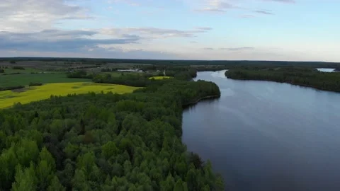 Lake in spring sunset 4k aerial top view. Fly above water of lake Dolgoe 動画素材 154533974