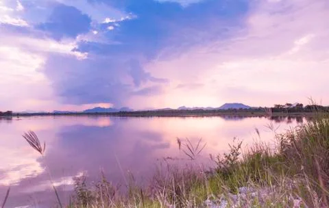 Lake summer view with reflection of clouds on water surface Stock Photos