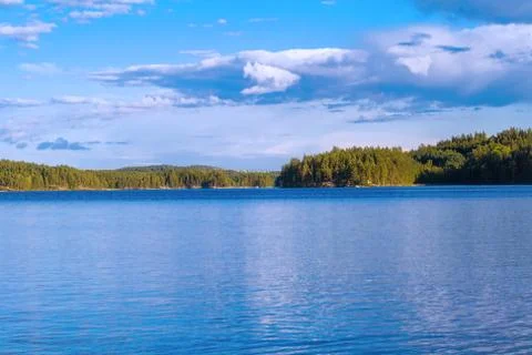 Lake summer view with reflection of clouds on water, Finland 스톡 사진