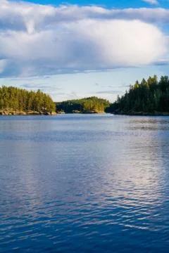 Lake summer view with reflection of clouds on water, Finland Stock Photos