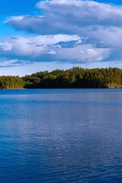Lake summer view with reflection of clouds on water, Finland Stock-Fotos