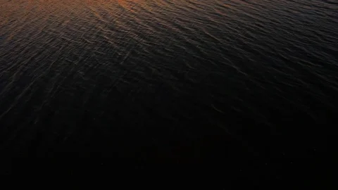 Lake at Sunset Beautiful Reflections Waves Drone Flying Over Vídeo Stock 128312936
