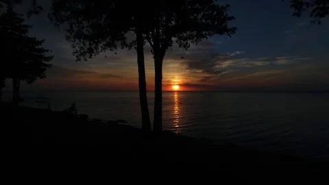 Lake Sunset Drone push past trees Stock Footage 91180577