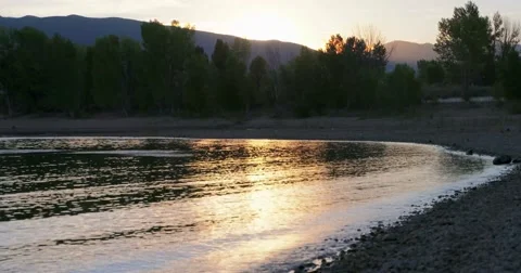 Lake at sunset with kayaker Vídeos de archivo 53821822