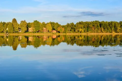 Lake in the sunset light. on the far side of the forest Stock Photos